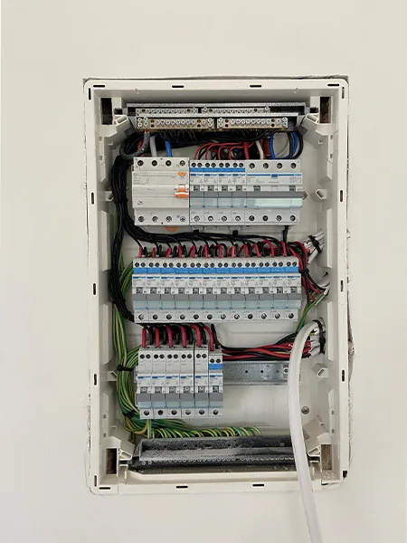 Certified electrician installing modern switchboard with safety features